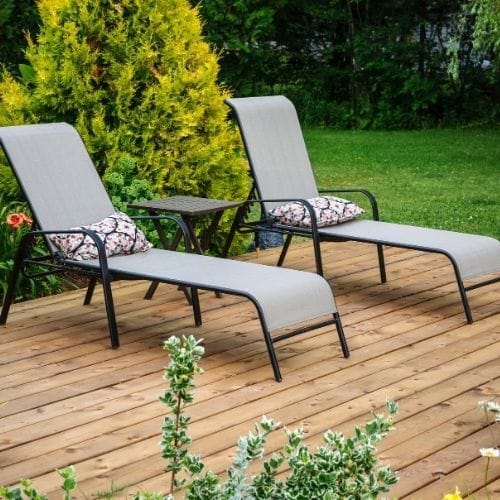 Comfortable sun loungers on a beautifully finished timber garden decking