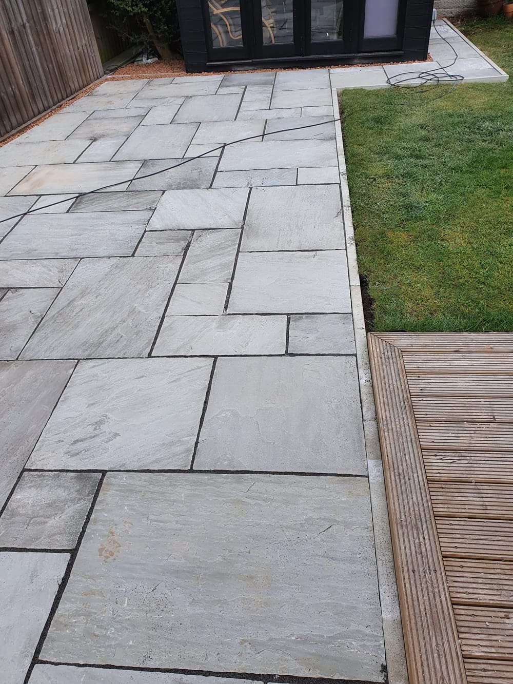 Finished outdoor space with paving and planting